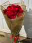 Dozen Red Premium LONG STEM Roses covered in colored waterproof paper                            (on the picture 25 roses )