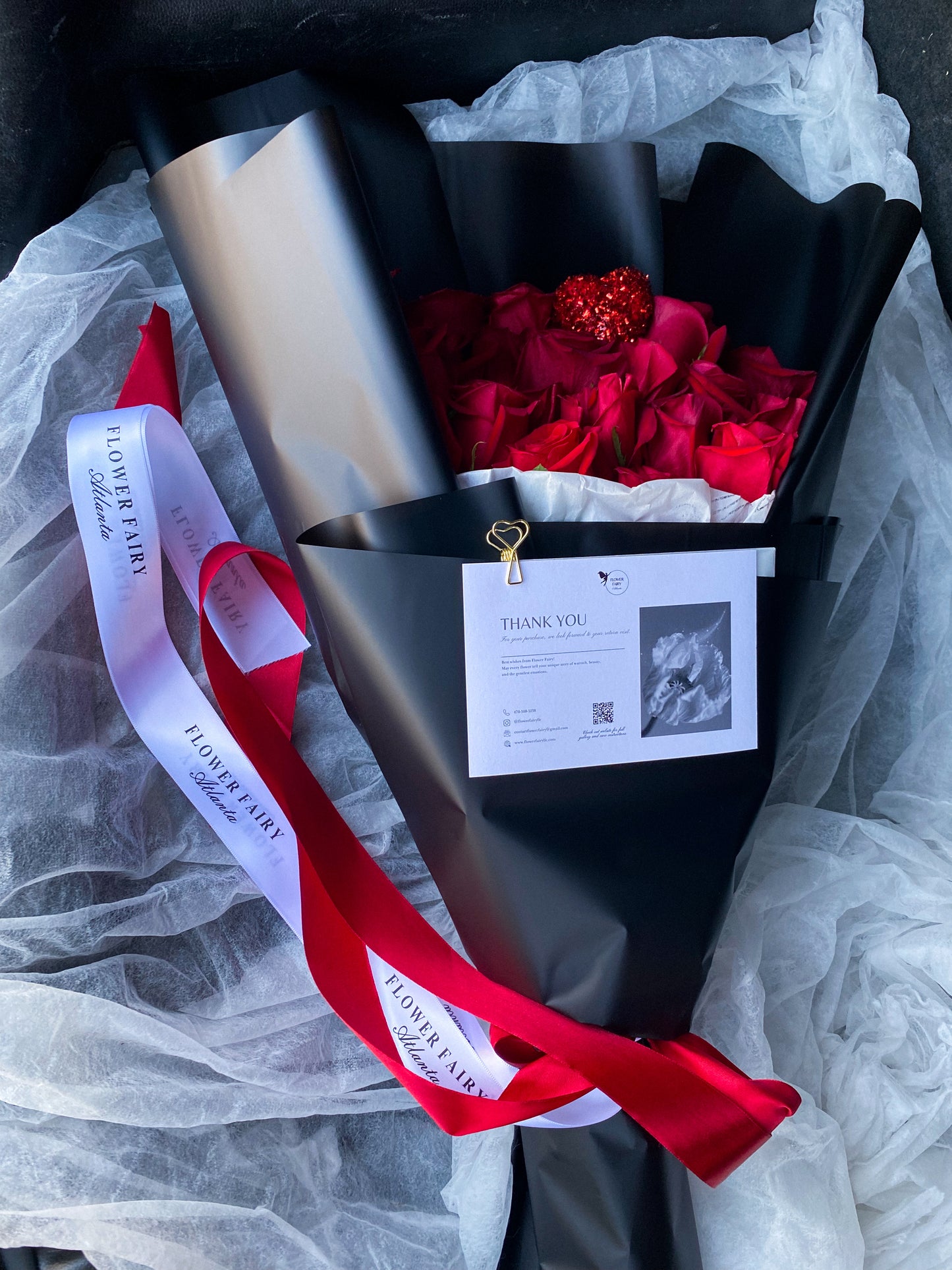 Dozen Red Premium   LONG STEM Roses covered in colored waterproof paper                            (on the picture 25 roses )