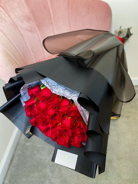 Dozen Red Premium LONG STEM Roses covered in colored waterproof paper (on the picture 25 roses )