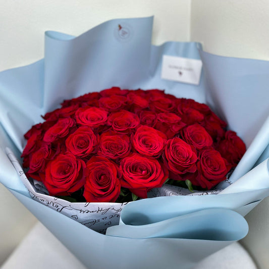 50 red roses in blue wrapping paper