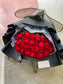 Dozen Red Premium LONG STEM Roses covered in colored waterproof paper                            (on the picture 25 roses )